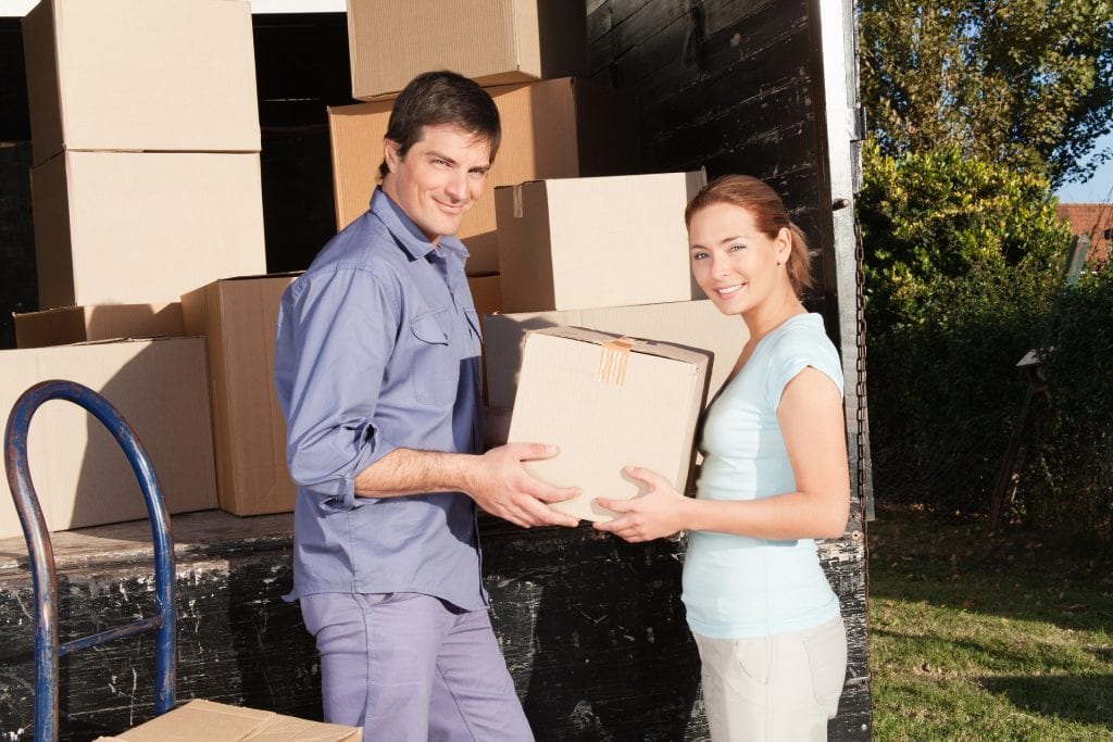 A man and woman holding a box